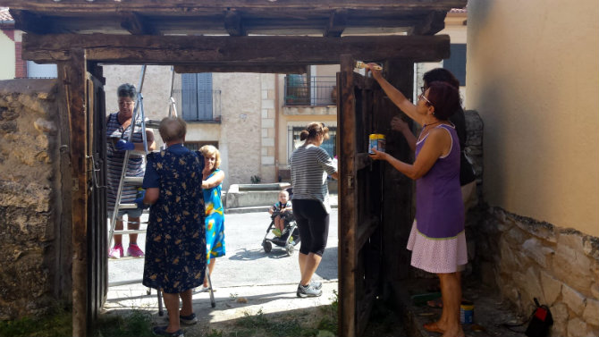 Mujeres restaurando una puerta de madera